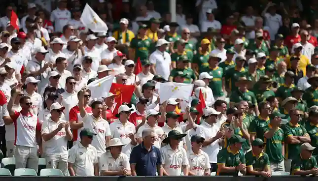 Passionate cricket crowd at Ashes match waving England and Australia flags